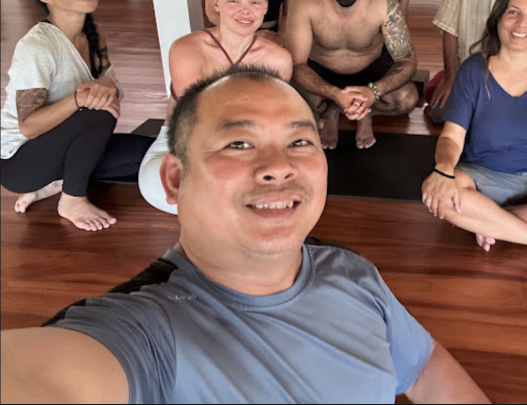 Vuth smiling with a small group after a massage and self-care session
